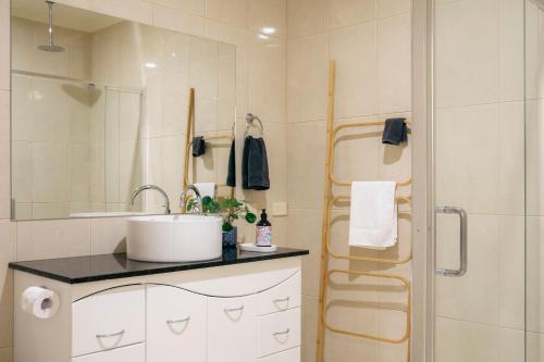 a bathroom with a sink and a shower at Halls Gap Escape Townhouses in Halls Gap