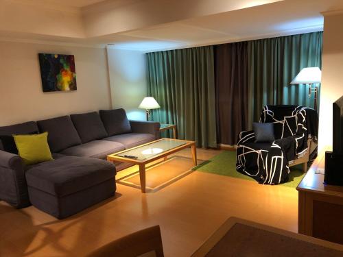 a living room with a couch and a table at Large family room near Metro Taipei station for comfort and convenience, where 5 can relax and create unforgettable moments in Taipei