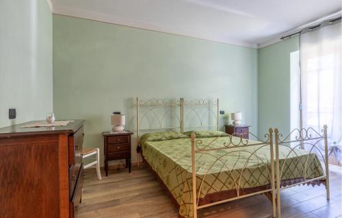 a bedroom with a bed and a dresser and a desk at Nice Apartment In Borgo A Mozzano in Borgo a Mozzano