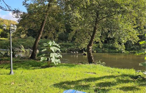 a view of a river with trees and a street light at Amazing Home In Ustka With Kitchen in Ustka