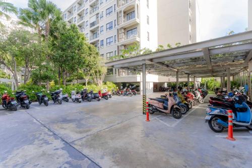 a group of motorcycles parked in a parking lot at Hua Hin La Casita Beautiful Two Bedroom Condo With Great Views in Hua Hin