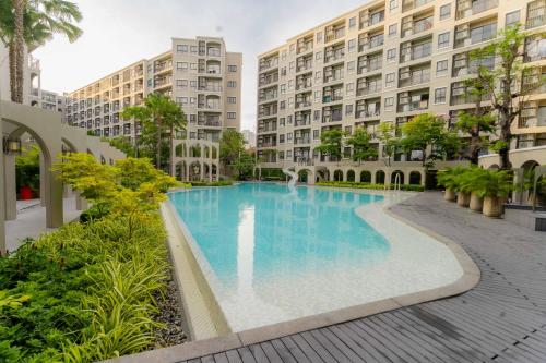 a large swimming pool in front of a building at Hua Hin La Casita Beautiful Two Bedroom Condo With Great Views in Hua Hin