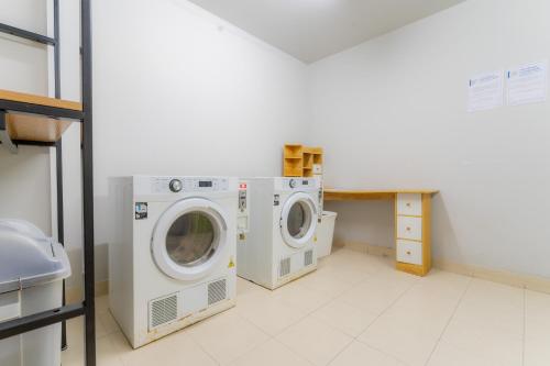 a laundry room with two washing machines in it at Hua Hin La Casita Beautiful Two Bedroom Condo With Great Views in Hua Hin