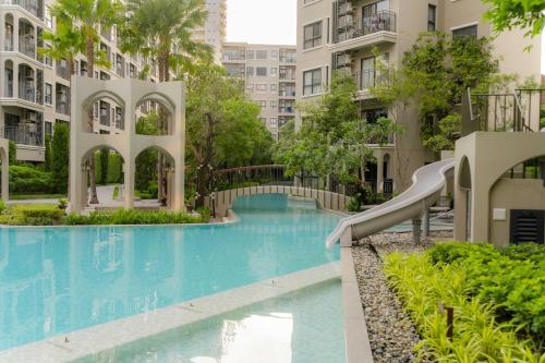 a swimming pool in a building with a slide at Hua Hin La Casita Beautiful Two Bedroom Condo With Great Views in Hua Hin