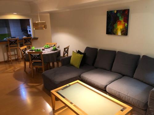 a living room with a couch and a table at Large family room near Metro Taipei station for comfort and convenience, where 5 can relax and create unforgettable moments in Taipei