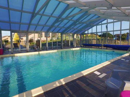 a large swimming pool with a blue ceiling at Apartment in Port-Bail near Sandy Beach in Port-Bail-sur-Mer