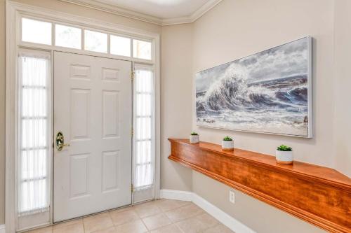 a home entry with a white door and a painting on the wall at Luxury 4-BR-BBQ-waterview-screened lanai-wood floors 211 in Saint Augustine
