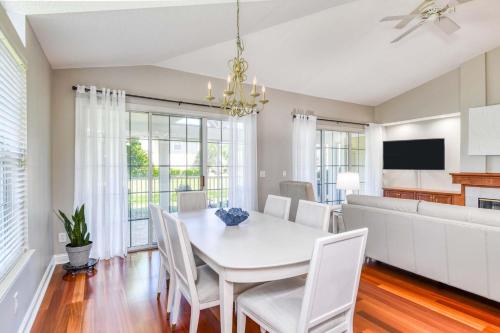 a dining room with a white table and chairs at Luxury 4-BR-BBQ-waterview-screened lanai-wood floors 211 in Saint Augustine