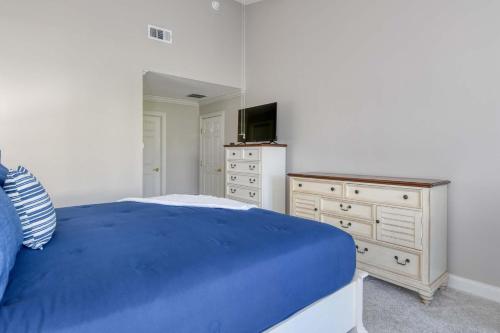 a bedroom with a blue bed and a dresser at Luxury 4-BR-BBQ-waterview-screened lanai-wood floors 211 in Saint Augustine