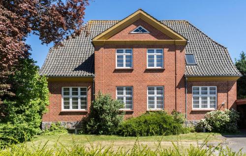 a red brick house with a gambrel roof at Cozy Apartment In Nordborg in Nordborg