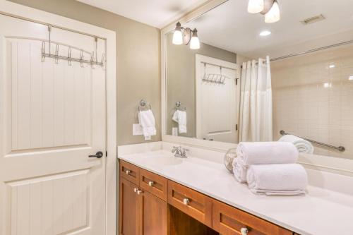 a white bathroom with a sink and a mirror at 4106-1 Cozy Ground Floor 1 BR with fenced patio in Saint Augustine