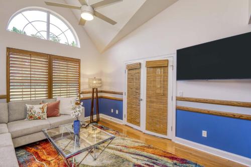 a living room with a couch and a flat screen tv at Spacious 3 BR plus SS in Den & screened lanai waterside in Sampson