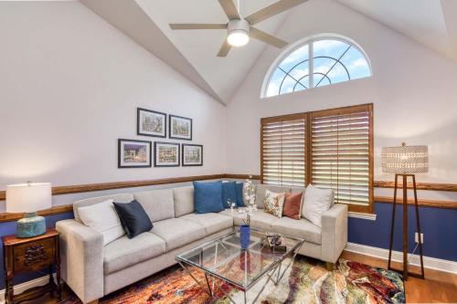 a living room with a couch and a glass table at Spacious 3 BR plus SS in Den & screened lanai waterside in Sampson