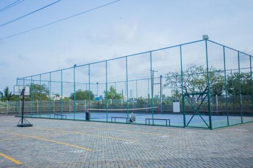 a batting cage with benches in a parking lot at Descent Studio Apartment at Signature in Accra