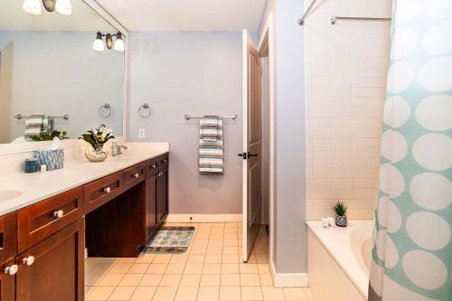 a bathroom with a tub and a sink and a shower at 4108-1P Relax in this 1 BR Peaceful Haven in Saint Augustine