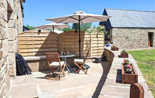 a patio with an umbrella and a table and chairs at Amazing Home In Louargat With Wifi in Louargat
