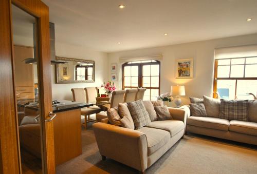 a living room with a couch and a table at Coastal Haven- stunning home in Crail in Crail