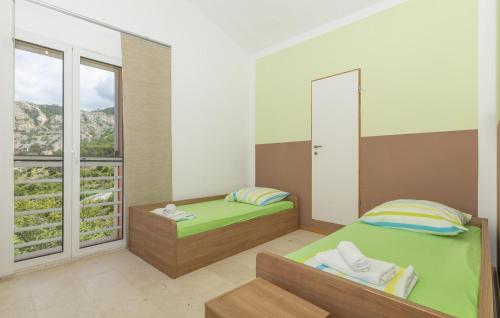 a room with two beds and a window at Amazing Apartment In Lukovo With Wifi in Lukovo