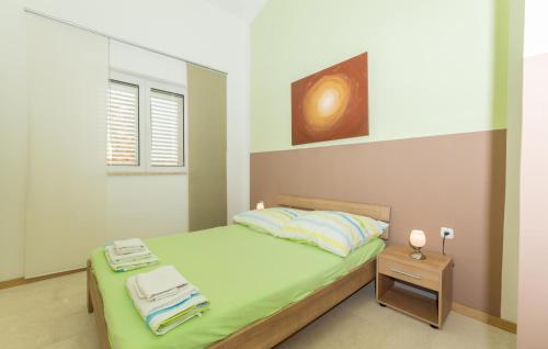 a bedroom with a bed with towels on it at Amazing Apartment In Lukovo With Wifi in Lukovo