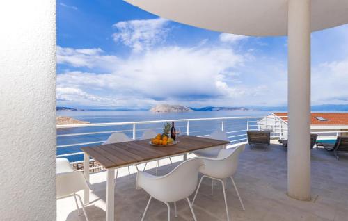a table on a balcony with a view of the ocean at 2 Bedroom Amazing Apartment In Lukovo in Lukovo