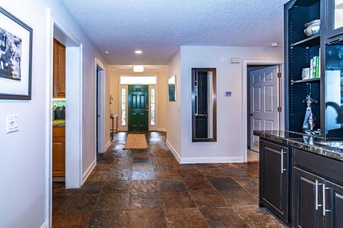 a hallway of a home with a kitchen with a counter at 4 bedroom - large screened lanai and views 414-4 in Sampson
