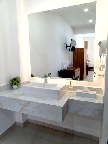 a bathroom with a large marble sink and a mirror at Punta Colibrí in Brisas de Zicatela