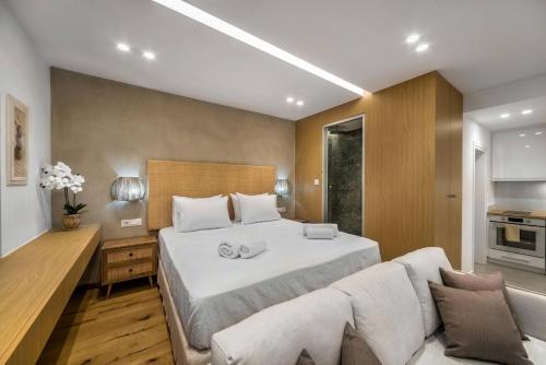 a bedroom with a large bed and a couch at Villa Kamelia with pool in Gournes