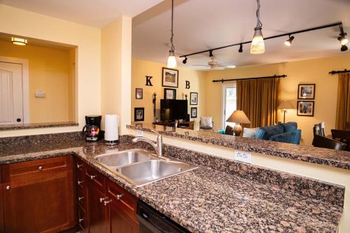 a kitchen with a sink and a living room at 2 BR Secluded patio with courtyard 5107P2 in Saint Augustine