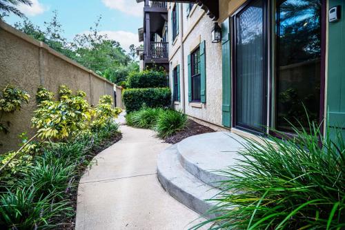 a sidewalk in front of a building with plants at 2 BR Secluded patio with courtyard 5107P2 in Saint Augustine