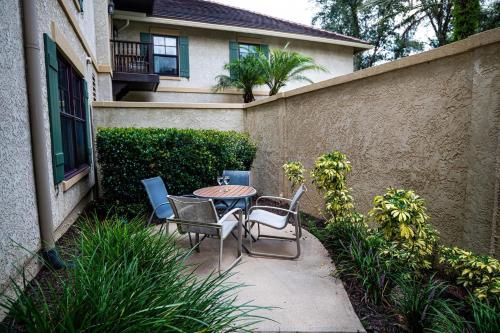 a patio with a table and chairs in front of a house at 2 BR Secluded patio with courtyard 5107P2 in Saint Augustine