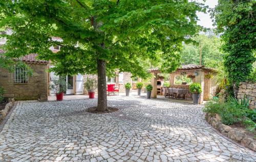 a tree in the middle of a cobblestone street at Amazing Home In Le Val in Le Val
