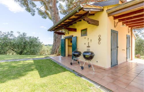 two bbq grills on the patio of a house at Poggioalvento in Lazzeretto