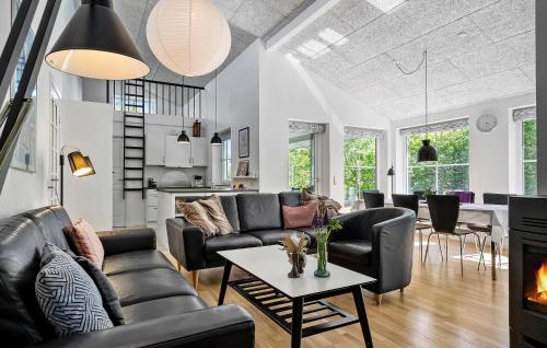 a living room with a couch and a table at Cozy Home In Ringkøbing With Sauna in Ringkøbing