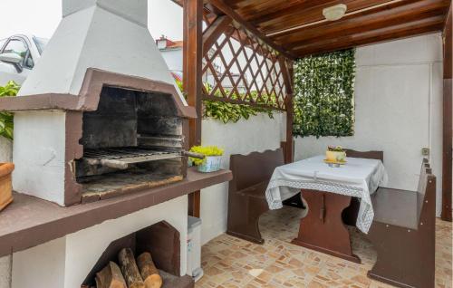 a patio with an outdoor oven with a table at Cozy Home In Selce With Wifi in Selce