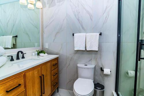 a bathroom with a toilet and a sink and a shower at 5208-LP King Suite with Kitchenette & Pool views in Saint Augustine
