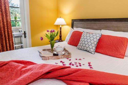 a bed with a tray of flowers and a vase on it at Luxurious-amazing Pool View from balcony 5216LP in Saint Augustine