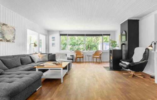 a living room with a couch and a table at 3 Bedroom Beautiful Home In Gilleleje in Gilleleje