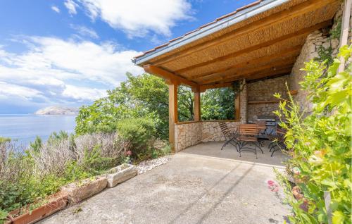 a patio with a table and chairs and the water at Nice Apartment In Lukovo With Wifi in Lukovo