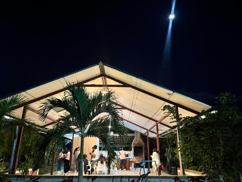 a building with people standing in front of it at night at Casa in Ahuashiyacu