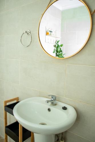 a bathroom with a white sink and a mirror at Kanana Villas - Maun 2 bedroom apartment in Maun