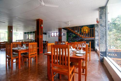 a dining room with wooden tables and chairs at Hotel City Grand Ella in Ella