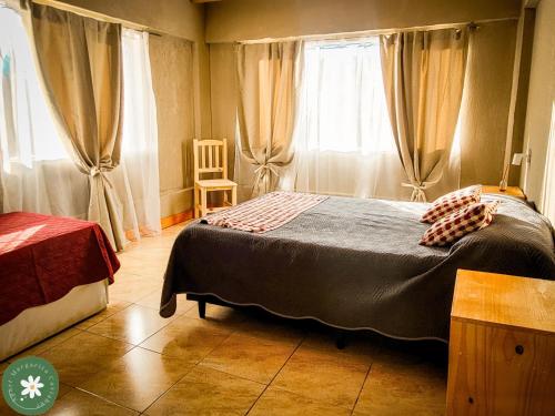 En eller flere senge i et værelse på Apart Margarita Caviahue