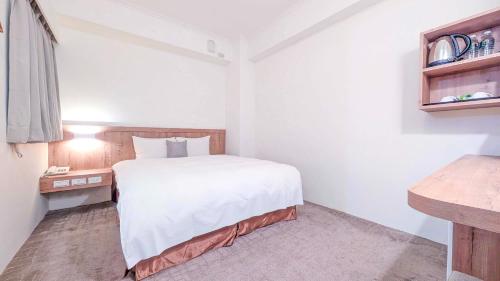 Postel nebo postele na pokoji v ubytování Foung Gu Hotel