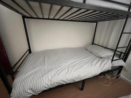 a bottom bunk bed in a room with at Cosy rooms in London in London