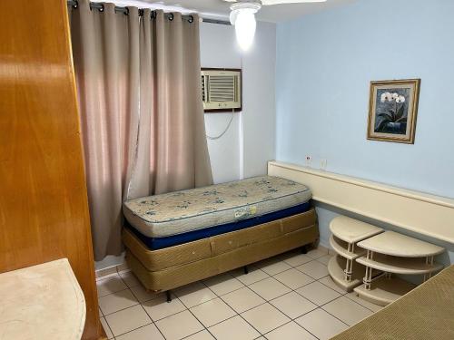 a small room with a bed and a window at Apartamentos Eldorado Thermas Park in Caldas Novas