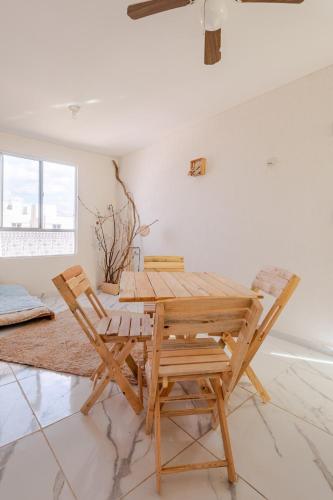a dining room with a wooden table and two chairs at Hippie Artisan Jungle Flat Pool in Tulum