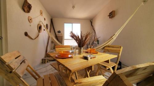 a dining room with a wooden table and chairs at Hippie Artisan Jungle Flat Pool in Tulum