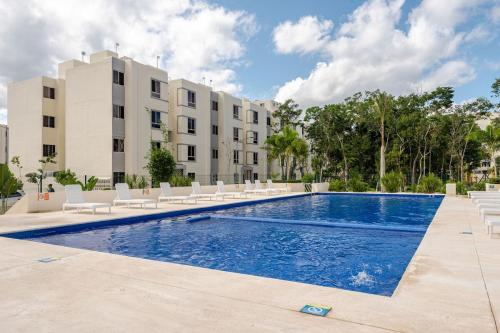 a swimming pool in front of a building at Hippie Artisan Jungle Flat Pool in Tulum