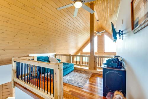a room with a crib and a ceiling fan at Mtn-View Deck Scenic Conway Log Cabin! in Conway