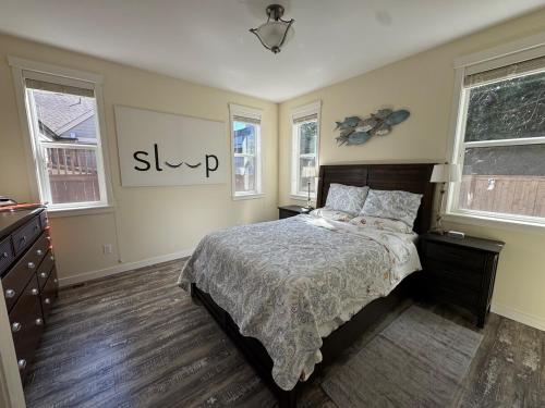 a bedroom with a bed and two windows at Family Comfy Kid Family Pet-Friendly Home Near Everything in Issaquah
